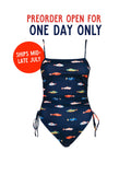 The PREORDER: Ruched Square Neck One Piece in Harbor by Kitty and Vibe features a navy base with colorful fish prints and adjustable straps. Preorder open for one day only—ships mid-late July.