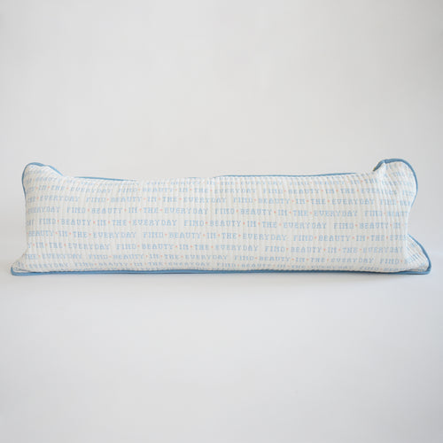 The Sara Fitz Lumbar Pillow, Cross Stitch Floral, features a long, rectangular cotton cover with a floral cross-stitch design and includes a plush down alternative insert for comfort.