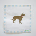 The Chocolate Pup Needlepoint by Sara Fitz is an 18 mesh canvas featuring a brown dog with a pink collar, centered on white fabric with blue and white striped borders and includes a needle attached to the upper left corner.