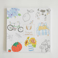 Discover the delightful cover of Coloring Book Countryside by Sara Fitz, showcasing whimsical New England illustrations—including a cow, lemon, bike, flowers, tomato, chair with cats, mushrooms, insects, and hydrangea. This adult coloring book perfectly captures the charming spirit of rural life in every detail.