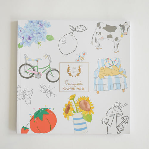 Discover the delightful cover of Coloring Book Countryside by Sara Fitz, showcasing whimsical New England illustrations—including a cow, lemon, bike, flowers, tomato, chair with cats, mushrooms, insects, and hydrangea. This adult coloring book perfectly captures the charming spirit of rural life in every detail.