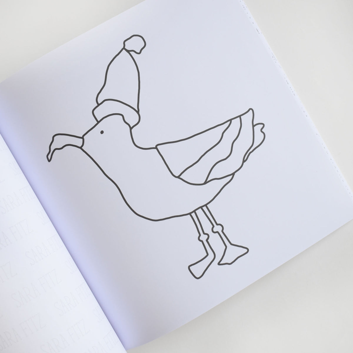 Line drawing of a seagull wearing a winter hat, from the Coloring Book Holiday by Sara Fitz.