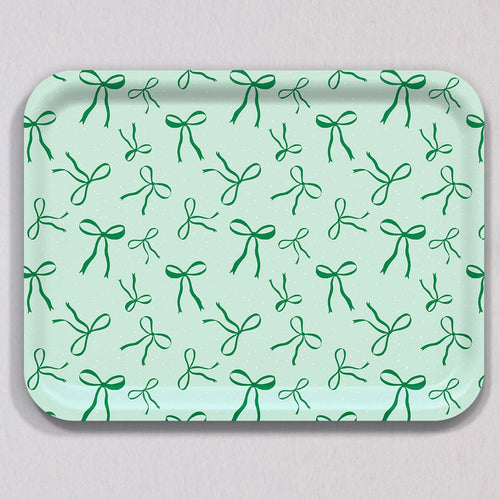 Large Green Bows Tray, a rectangular birch wood tray featuring a repeating pattern of green bows on a pale green background with white speckles.