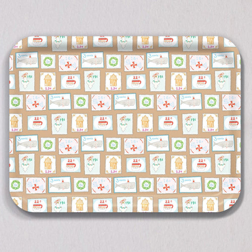 Large Holiday Stamps Tray, a rectangular melamine coated tray featuring a repeating pattern of holiday-themed postage stamps, including illustrations of Santa, whales, gingerbread houses, and wreaths.