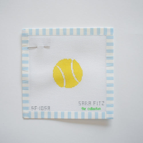 The MINI Tennis Ball Needlepoint by Sara Fitz features a stitch-painted yellow tennis ball on white 18 mesh canvas, bordered by blue and white stripes, with “SF-105A,” “SAKA PILZ,” and “The Collection” in green at the bottom.