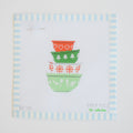 The Mixing Bowls Needlepoint by Sara Fitz features four vintage patterned mixing bowls in red and green on white fabric, framed with pale blue and white stripes.