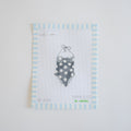 The MINI Polka Dot Swimsuit Needlepoint by Sara Fitz features a cross-stitch design of a polka-dotted swimsuit on white fabric with a blue and white striped border, stitched on 18 mesh canvas. "Sara Fitz the collection" appears at the bottom.