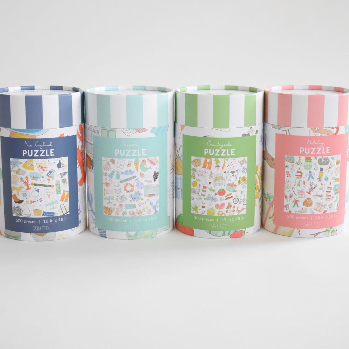 Four cylindrical Holiday Puzzle containers featuring colorful holiday illustrations and varying striped lids.