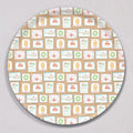 Large Holiday Stamps Tray, Round, featuring a repeating pattern of holiday-themed postage stamps with illustrations of whales, gingerbread houses, wreaths, and Santa Claus.