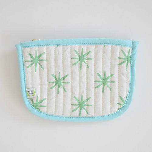 The Coin Pouch, Green Star by Sara Fitz is a cotton quilted pouch with a light blue border and zipper, white background with green starburst patterns, and a small side label. Made in India—ideal as a stylish card holder.