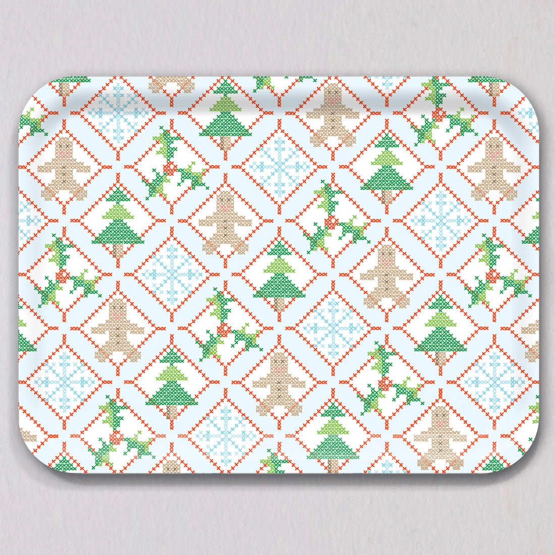 Large Holiday Cross Stitch Tray by Sara Fitz, a rectangular melamine coated tray featuring a repeating cross-stitch pattern of gingerbread men, Christmas trees, snowflakes, and holly sprigs framed by red dashed diamonds.