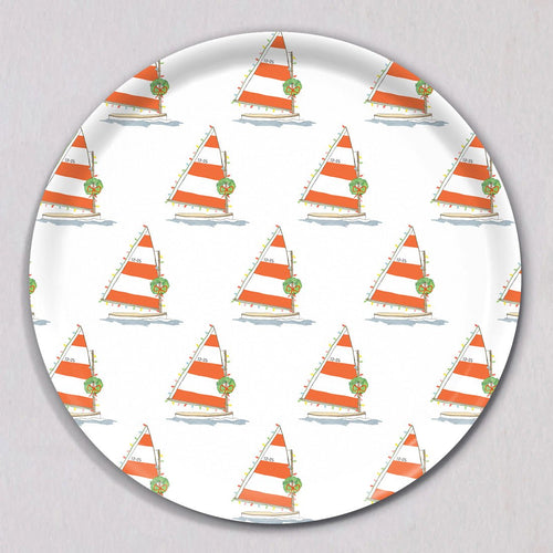Large Holiday Sailboat Tray, Round, featuring a repeating pattern of sailboats with orange and white striped sails, decorated with Christmas wreaths and string lights on a melamine coated birch wood surface.
