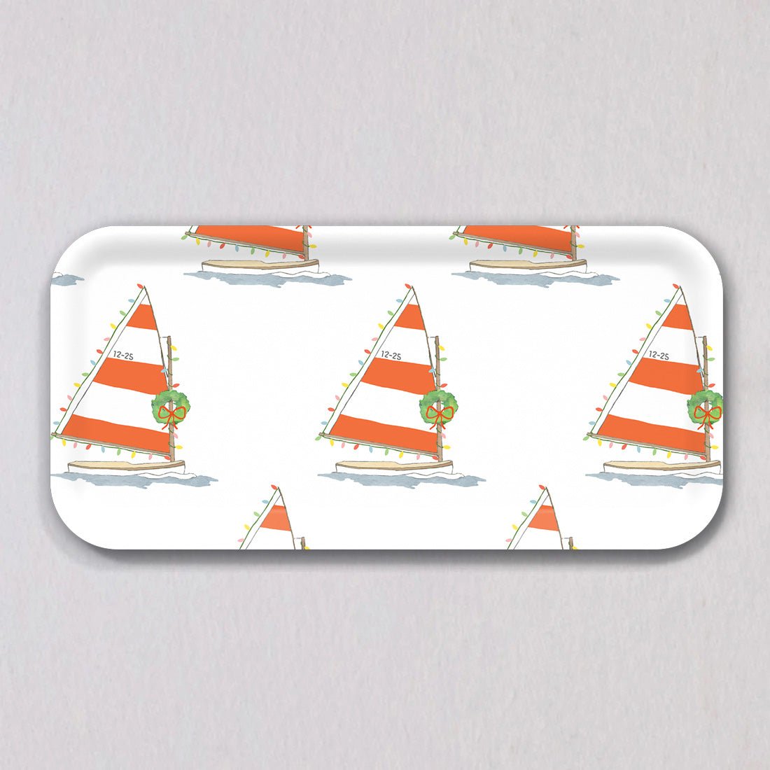 Small Holiday Sailboat Tray: a rectangular birch wood tray decorated with a repeating pattern of sailboats featuring orange and white striped sails, string lights, and Christmas wreaths.