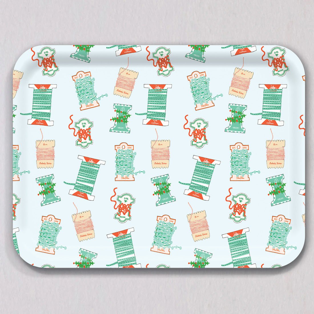 Large Holiday Trimmings Tray by Sara Fitz: a rectangular melamine-coated birch wood tray featuring a repeating pattern of colorful spools of holiday ribbon and twine.
