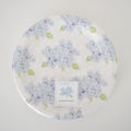 Sara Fitz Hydrangea Paper Salad Plates, 8-inch, feature blue and purple hydrangea flowers with green leaves. Pack of 16 salad plates, wrapped in plastic.