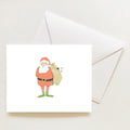 A Santa Fitz Note Card boxed set featuring an illustration of Santa Claus carrying a sack labeled to go, resting next to a white envelope.