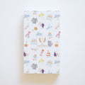 A vertical keepsake box for the 2027 Desk Calendar, featuring a repeating pattern of nautical and floral watercolor illustrations and a center label reading Sara Fitz - 2027 - Desk Calendar.
