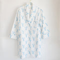 The Blue Lobster Sleep Shirt by Sara Fitz, featuring long white cotton sleeves and a playful blue lobster print, hangs on a gold hanger against a plain white background—bringing the perfect touch of whimsy to women’s sleepwear.