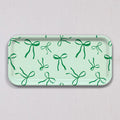 Small Green Bows Tray, a rectangular light green birch wood tray featuring a repeating pattern of dark green bows.