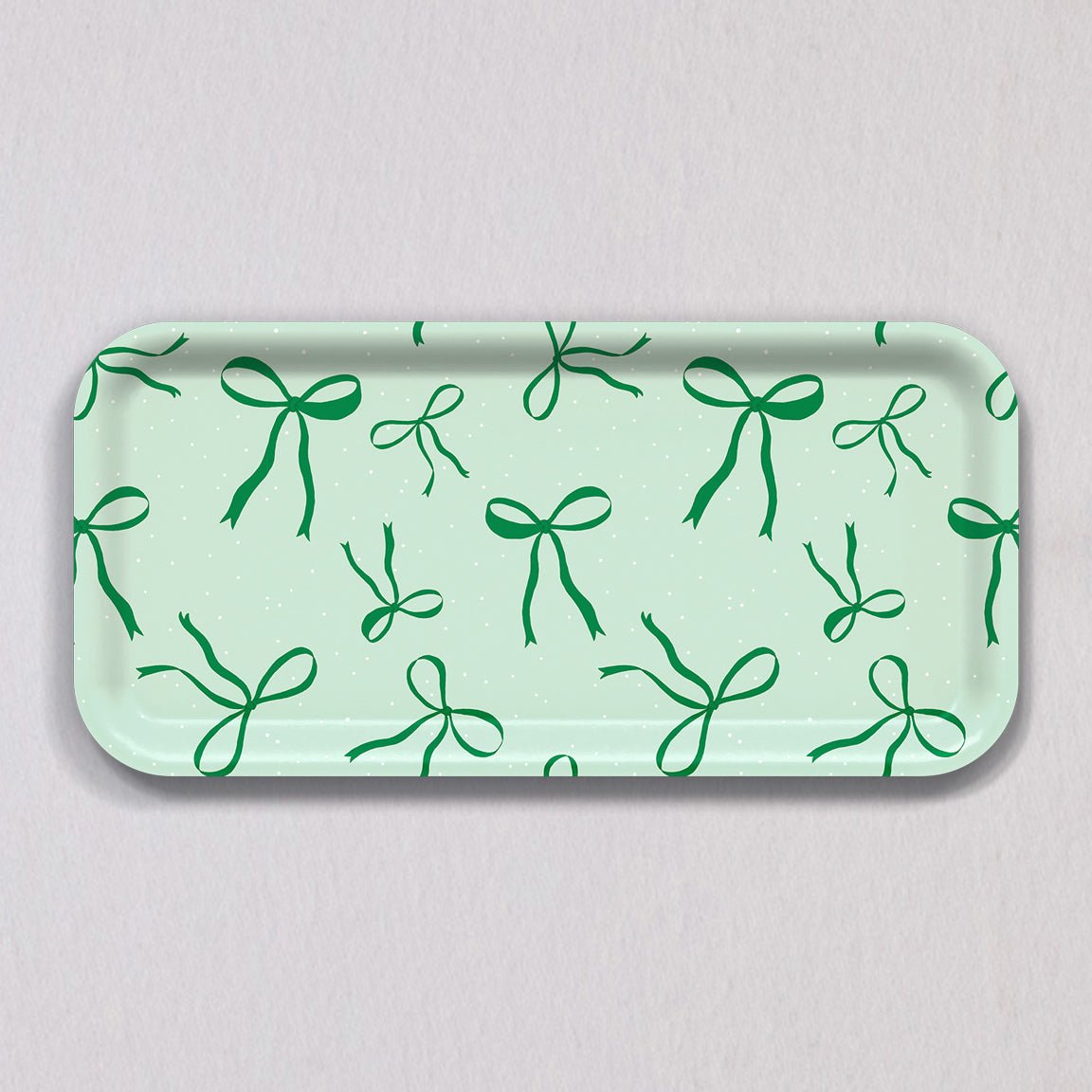 Small Green Bows Tray, a rectangular light green birch wood tray featuring a repeating pattern of dark green bows.