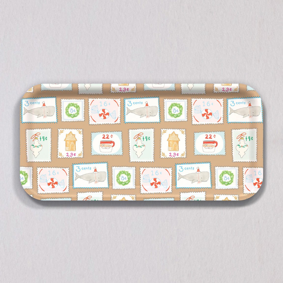 Sara Fitz Small Holiday Stamps Tray: a rectangular, melamine-coated tray patterned with vintage-style holiday postage stamps featuring illustrations of whales, gingerbread houses, wreaths, and candy.
