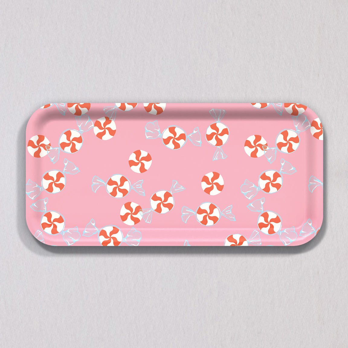 Small Peppermint Candy Tray, a rectangular pink melamine-coated birch wood tray with a repeating pattern of red and white peppermint candies.