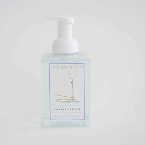 Sara Fitz Foaming Soap Sailboat is a clear pump bottle with a minimalist sailboat design and blue-white label, offering a fresh cotton scent in 16.9 fl oz (500 ml) of non-toxic foaming hand soap.