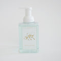 The Sara Fitz Foaming Soap Fresh Cotton comes in a clear pump bottle with a cotton plant illustration on white. This 300 ml non-toxic soap gently refreshes your hands with every use.