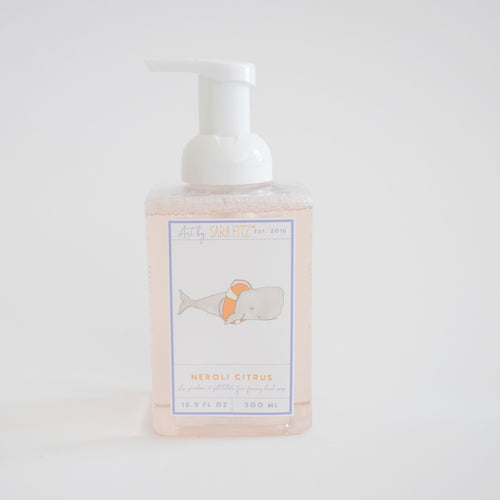 Sara Fitz Foaming Soap Whale features a clear 500ml bottle with a white pump, a label showing a whale with an orange float, and "Neroli Citrus" scent. Highlights include its fresh fragrance and non-toxic formula.
