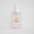 A clear pump bottle of Sara Fitz Foaming Soap Pomelo displays an illustration of sliced pomelo fruit on the label, set against a plain white background.