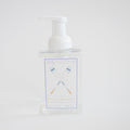 Sara Fitz Foaming Soap Oars comes in a clear 16.9 fl oz (500 ml) pump bottle labeled Sea Salt Driftwood, featuring non-toxic foaming soap and an illustration of two crossed blue and white oars on a white background.