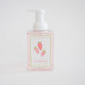 A clear pump bottle of pink foaming soap labeled Sara Fitz Foaming Soap Strawberries, featuring three illustrated strawberries, non-toxic ingredients, and extra product details.