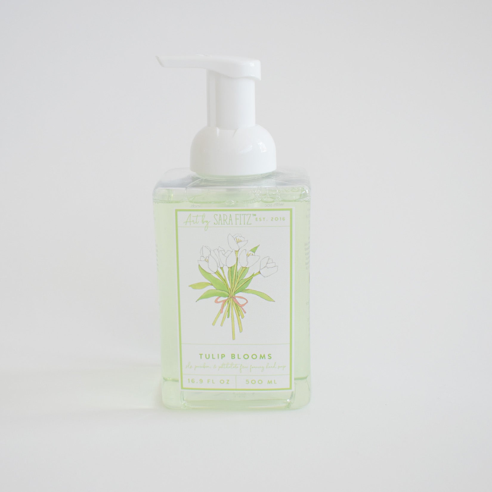 Foaming Soap Tulip Blooms by Sara Fitz comes in a clear plastic pump bottle with a front label depicting white tulips and green stems. Non-toxic and gentle, it's ideal for everyday use.