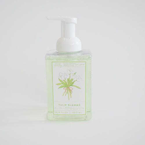 Foaming Soap Tulip Blooms by Sara Fitz comes in a clear plastic pump bottle with a front label depicting white tulips and green stems. Non-toxic and gentle, it's ideal for everyday use.