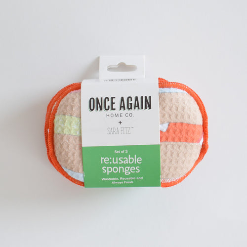 Three colorful patterned Re:usable Sponge, Stockings in packaging labeled Once Again Home Co. + Sara Fitz.