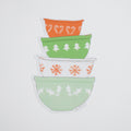 A Sara Fitz Mixing Bowls sticker featuring a stack of four colorful bowls decorated with Christmas patterns including candy canes, pine trees, and snowflakes.