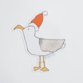 Watercolor illustration of a Santa Gull Sticker featuring a seagull wearing a red and white Santa hat.